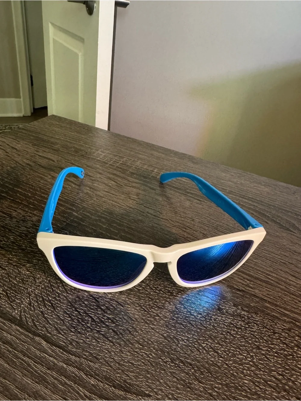 Oakley White Frame Sunglasses with Blue Mirrored Lenses